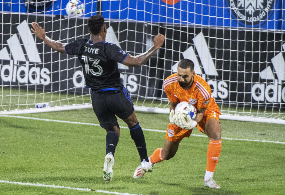 New York Red Bulls goalkeeper Carlos Coronel makes a save as CF Montreal's Mason Toye moves in during the second half of an MLS soccer match Wednesday, Aug. 31, 2022, in Montreal. (Graham Hughes/The Canadian Press via AP)