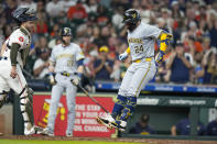 Milwaukee Brewers' William Contreras (24) jumps on home plate after hitting a three-run home run against the Houston Astros during the fifth inning of a baseball game Saturday, May 18, 2024, in Houston. (AP Photo/Eric Christian Smith)