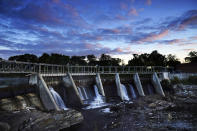 The Weston Dam holds back the Kennebec River, Tuesday, Sept. 14, 2021, in Skowhegan, Maine. Conservation groups recently filed a federal lawsuit against the Brookfield Renewable, owner of four dams along the Kennebec River, including Westin, alleging that the company is violating the Endangered Species Act. (AP Photo/Robert F. Bukaty)