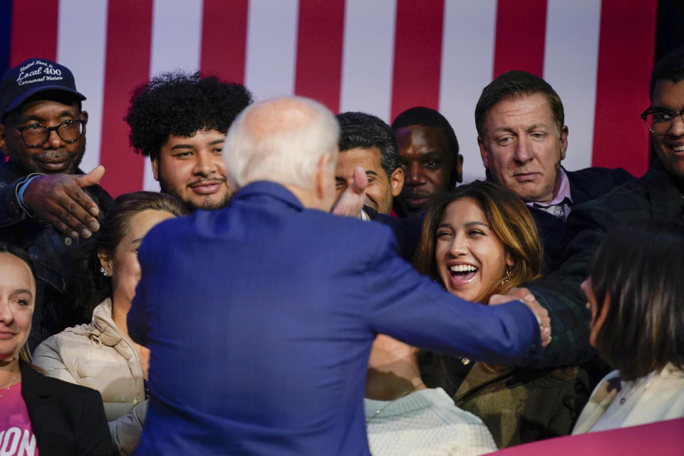 FILE - President Joe Biden greets people on stage after speaking about abortion access during a Democratic National Committee event at the Howard Theatre, Oct. 18, 2022, in Washington. (AP Photo/Evan Vucci, File)