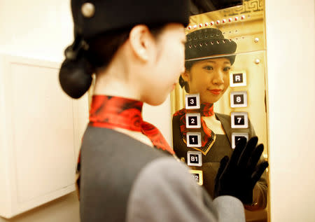 22-year-old elevator operator Yuria Nagamoto works at Takashimaya department store in Tokyo, Japan October 18, 2018. Picture taken October 18, 2018. REUTERS/Issei Kato