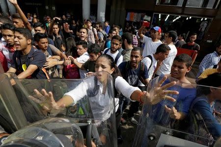 Manifestantes opositores chocan con la policía antidisturbios frente a una corte en Caracas. 31 de marzo de 2017. REUTERS/Marco Bello