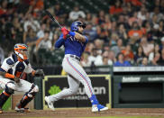 Texas Rangers' Joey Gallo, right, hits a RBI-double as Houston Astros catcher Martin Maldonado watches during the fourth inning of a baseball game Tuesday, June 15, 2021, in Houston. (AP Photo/David J. Phillip)