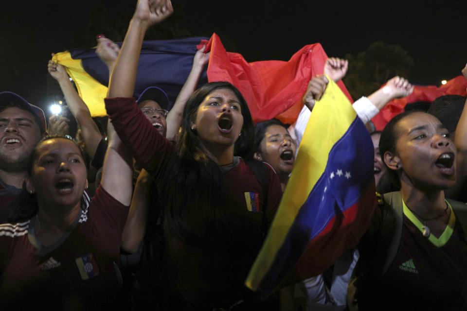 Venezuelans protest in support of Juan Guaido, head of the opposition-run congress, after he proclaimed himself the country's interim president, in Lima, Peru, Wednesday, Jan. 23, 2019. Venezuela's crisis quickly escalated as the opposition leader backed by the Trump administration declared himself interim president in a direct challenge to Maduro, who retaliated by breaking off relations with the United States, his biggest trade partner. (AP Photo/Martin Mejia)