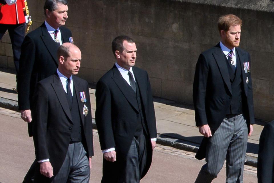 Britain's Prince William, Duke of Cambridge, Britain's Prince Harry, Duke of Sussex and Peter Phillips follow the hearse, a specially modified Land Rover, during the funeral of Britain's Prince Philip, husband of Queen Elizabeth, who died at the age of 99, on the grounds of Windsor Castle in Windsor, Britain, April 17, 2021. Leon Neal/Pool via REUTERS
