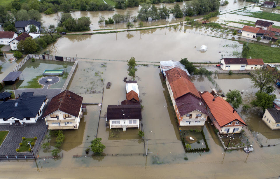 This aerial photo shows flooded neighborhood in Sanski Most, Bosnia-Herzegovina, Tuesday, May 14, 2019. Homes and roads have been flooded in parts of Bosnia after rivers broke their banks following heavy rains, triggering concerns Tuesday of a repeat of floods five years ago when dozens died. (AP Photo/Darko Bandic)