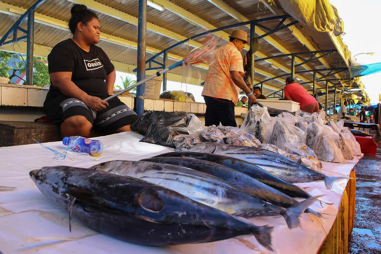 This picture taken on December 17, 2022 shows a fishmonger waiting for customers at the downtown market in Fiji's capital city Suva