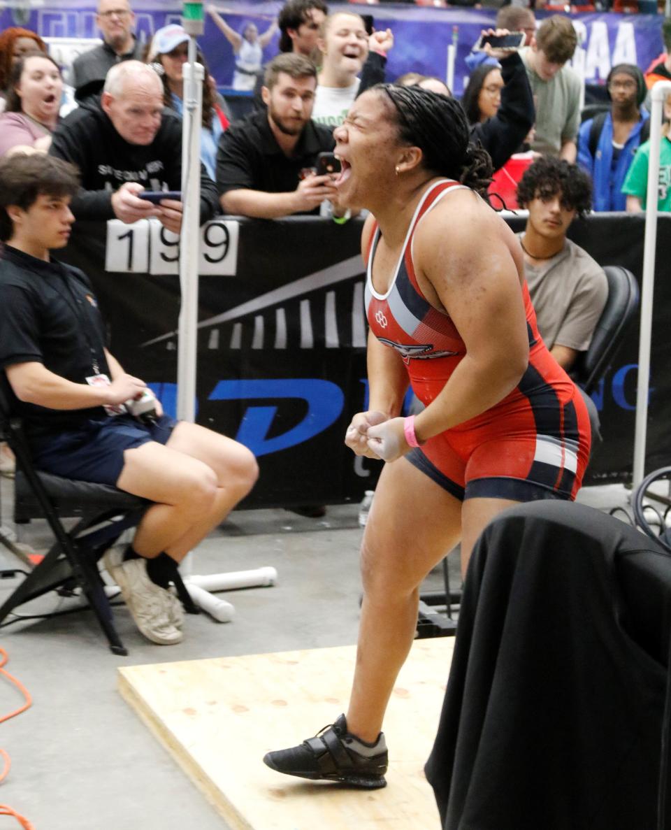 New Smyrna Beach's Asha-Mahri Manzueta celebrates after setting an FHSAA 199-pound bench press record with a 310-pound lift.