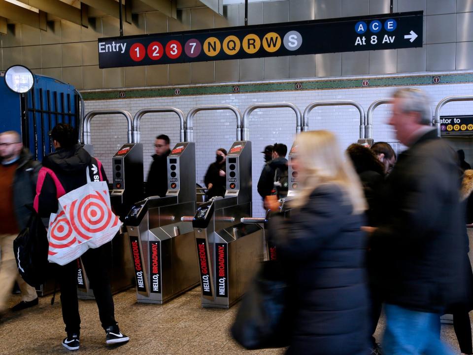 People walk through Times Square Subway Station on December 2, 2022 in New York City.