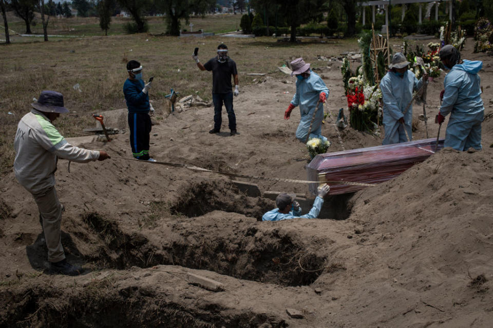Two family members film the makeshift funeral in Mexico City. Source: Getty