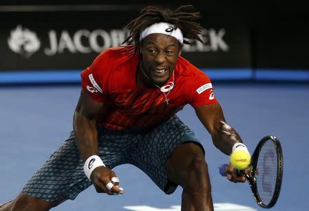 France's Monfils hits a shot with his left hand during his quarter-final match against Canada's Raonic at the Australian Open tennis tournament at Melbourne Park