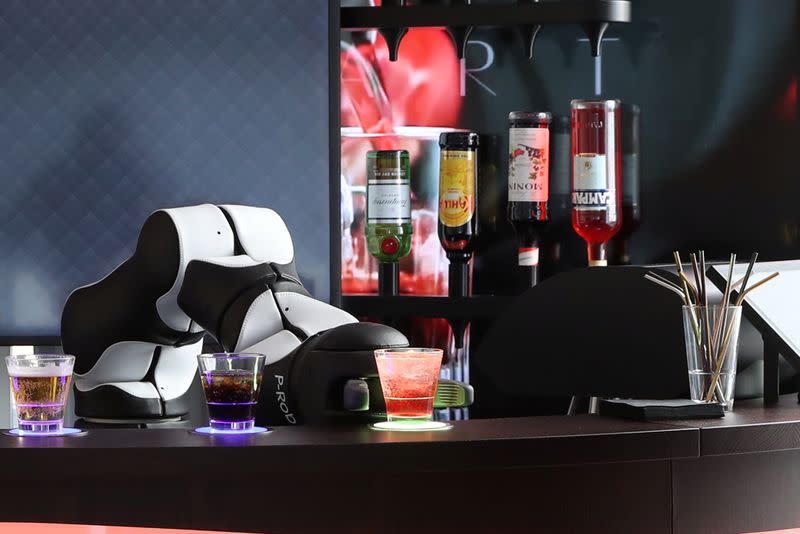 A robotic arm serves a Campari Soda at the Barney Cocktail Bar