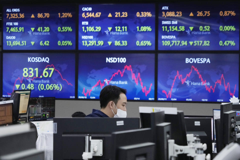 A currency trader watches monitors at the foreign exchange dealing room of the KEB Hana Bank headquarters in Seoul, South Korea, Friday, Aug. 12, 2022. Shares were mixed Friday in Asia after a muddled day on Wall Street, where benchmarks meandered following another encouraging report about inflation. (AP Photo/Ahn Young-joon)