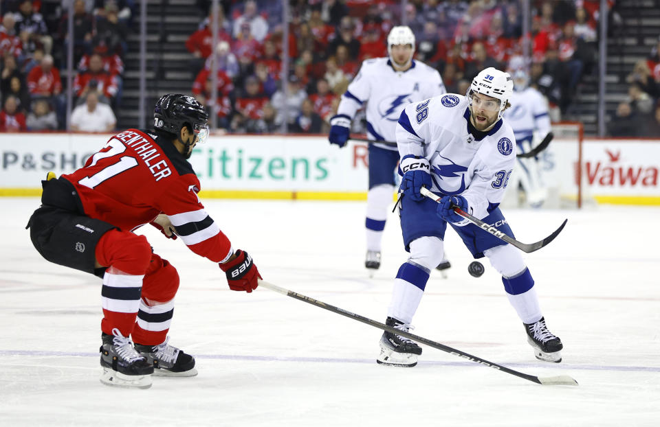 Tampa Bay Lightning left wing Brandon Hagel (38) shoots the puck against New Jersey Devils right wing Yushiroh Hirano (71) during the first period of an NHL hockey game, Sunday, Feb. 25, 2024, in Newark, N.J. (AP Photo/Noah K. Murray)