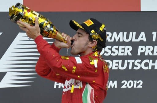 Ferrari's Spanish driver Fernando Alonso celebrates on the podium at the Hockenheimring circuit during the German Formula One Grand Prix. Alonso extended his lead in this year's Formula One drivers' world championship on Sunday when he drove to a flawless victory for Ferrari in the German Grand Prix