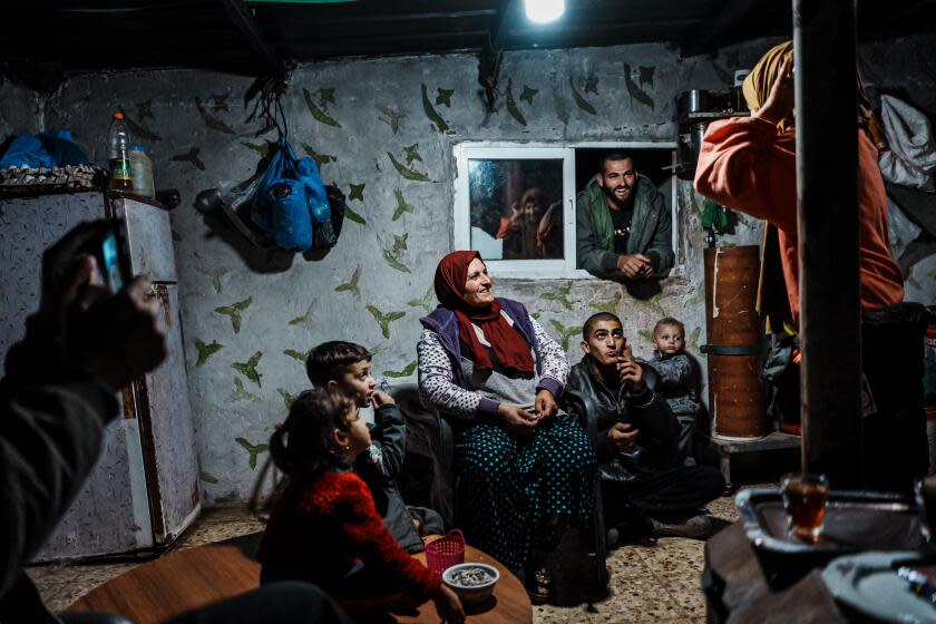 SHAEB AL-BOTUM, OCCUPIED WEST BANK -- NOVEMBER 15, 2023: A Palestinian family exchange jokes during dinner time in Shaeb Al-Botum, Occupied West Bank, Wednesday, Nov. 15, 2023. IsraelOs war against Hamas in Gaza has intensified the settler movement in the Israeli occupied West Bank, where for decades Jewish enclaves have risen from strategic high grounds to prevent an independent Palestinian state. About 500,000 settlers, with the help of army and police, essentially have free rein amid 2.7 million Palestinians. Nearly 1,000 Palestinians have fled West Bank villages and small communities in recent weeks after settlers demolished and burned homes, destroyed olive trees, blocked roads, and cut off electricity and water, according to BOTselem, an Israeli human rights group. Much of the harassment and violence reverberate through Area C, which covers about 60 percent of the West Bank and is home to about 130 Jewish settlements and 100 outposts. The region is administered by the autonomous Palestinian Authority but controlled by Israeli forces. The Jewish settlements D Palestinians face restrictions on developing land D are considered by most nations an illegal Israeli design to annex territory in the Jordan Valley and Judean Desert. (MARCUS YAM / LOS ANGELES TIMES)