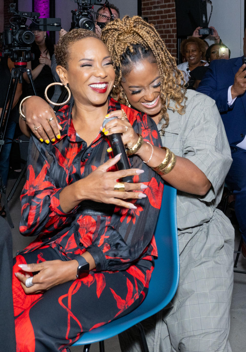 <strong>MC Lyte</strong> and <strong>Rapsody</strong> share a loving laugh.