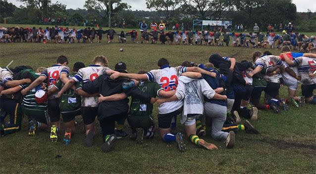 Warringah and Eastwood players observe a moment's silenceduring the under-17 championships. Source: Facebook