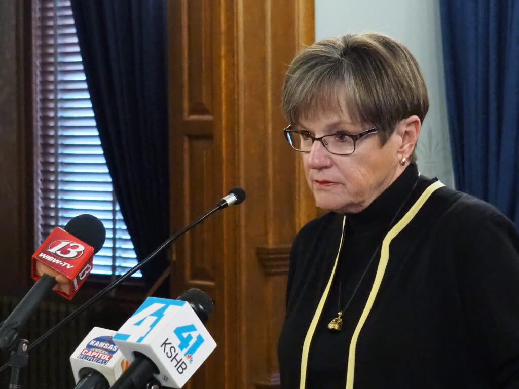 Gov. Laura Kelly and Attorney General Kris Kobach welcoming signing into law a bill substantively elevating state financial awards to victims of crime. (Tim Carpenter/Kansas Reflector)