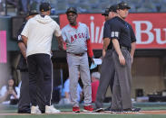 Los Angeles Angels manager Ron Washington, center, brings out the lineup before the team's baseball game against the Texas Rangers in Arlington, Texas, Friday, May 17, 2024. (AP Photo/LM Otero)
