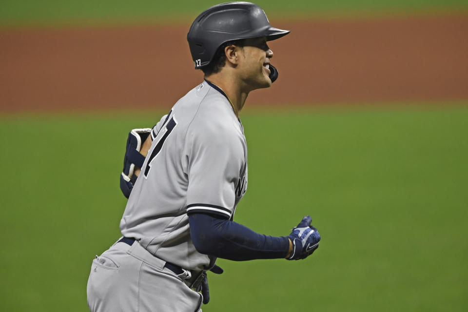 New York Yankees' Giancarlo Stanton (27) runs the bases after hitting a solo home run off Cleveland Indians relief pitcher Cam Hill (27) in the ninth inning of Game 1 of an American League wild-card baseball series, Tuesday, Sept. 29, 2020, in Cleveland. The Yankees won 12-3. (AP Photo/David Dermer)