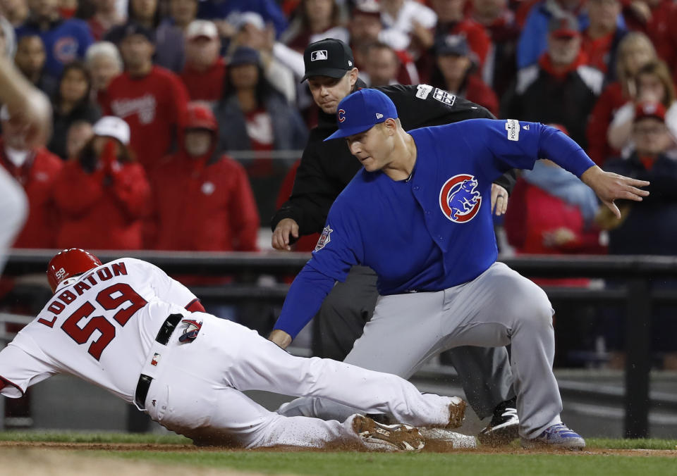 Chicago Cubs first baseman Anthony Rizzo picks off Washington Nationals' Jose Lobaton in Game 5 of baseball's National League Division Series against the Chicago Cubs. (AP)