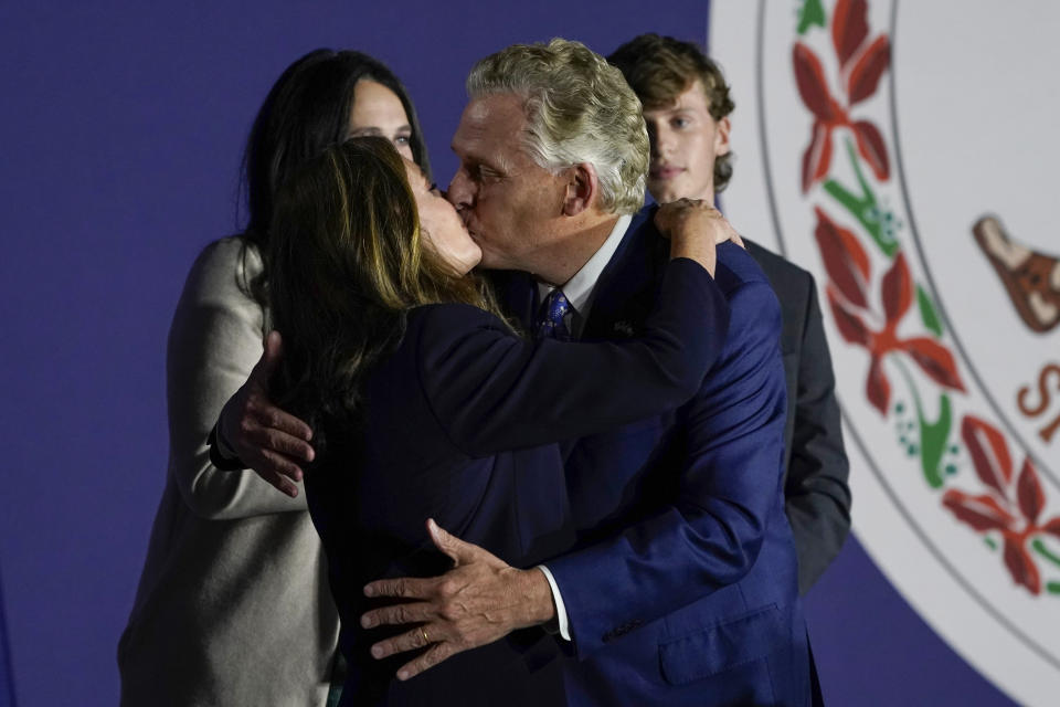 Democratic gubernatorial candidate Terry McAuliffe, right, kisses his wife, Dorothy, as he makes an appearance at an election night party in McLean, Va., Tuesday, Nov. 2, 2021. Voters are deciding between Democrat Terry McAuliffe and Republican Glenn Youngkin. (AP Photo/Steve Helber)