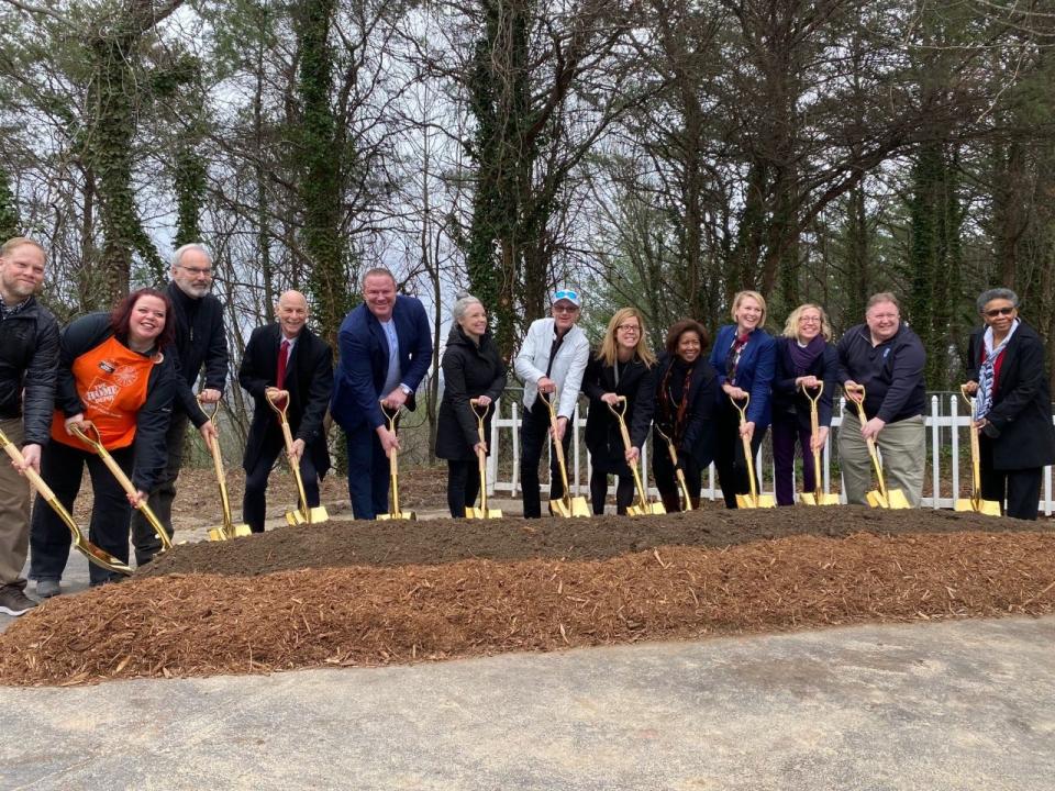 City staff, project partners, elected officials and the CEOs of Step  Up and Shangri-La pose at the Dec. 13, 2022 groundbreaking of 113 units of permanent supportive housing at the former Ramada Inn.