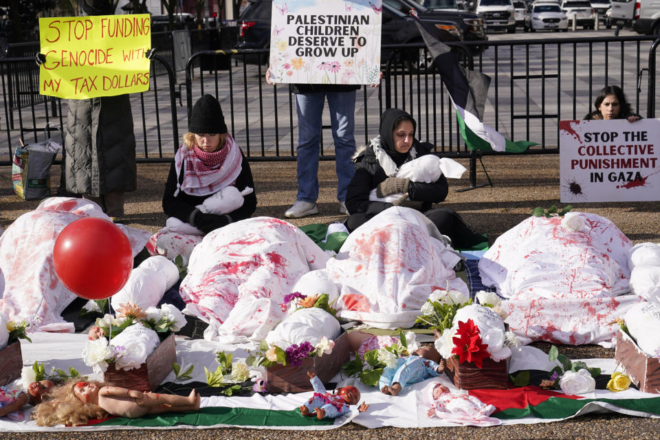 People gather outside the White House in Washington, Monday, Dec. 11, 2023, to protest the killing of civilians during the Israel-Hamas war. (AP Photo/Susan Walsh)