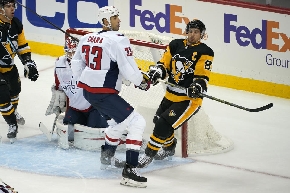 Washington Capitals' Zdeno Chara (33) defends against Pittsburgh Penguins' Sidney Crosby (87) during the first period of an NHL hockey game in Pittsburgh, Sunday, Jan. 17, 2021. (AP Photo/Gene J. Puskar)