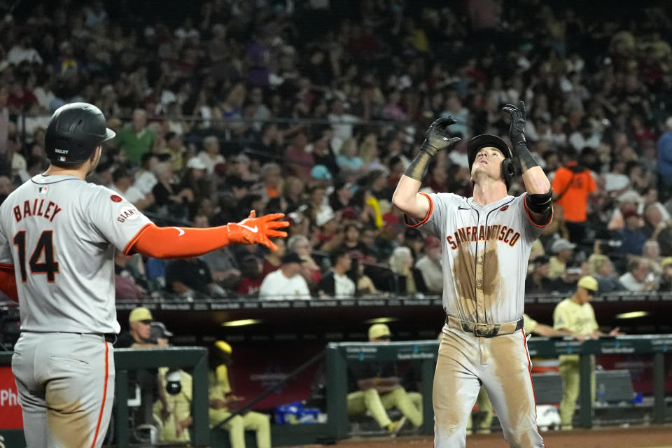 San Francisco Giants' Tyler Fitzgerald, right, celebrates his two-run home run against the Arizona Diamondbacks as Giants' Patrick Bailey (14) looks on during the fifth inning of a baseball game Tuesday, Sept. 24, 2024, in Phoenix. (AP Photo/Ross D. Franklin)