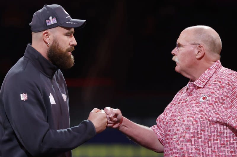 Kansas City Chiefs tight end Travis Kelce (L) greets head coach Andy Reid at Super Bowl Opening Night on Monday at Allegiant Stadium in Las Vegas. Photo by John Angelillo/UPI