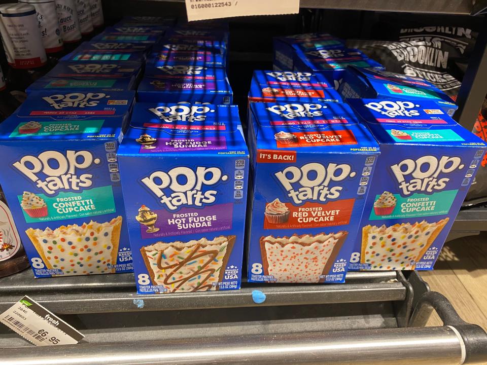 boxes of different flavors of pop tarts on the shelves of an irish grocery store