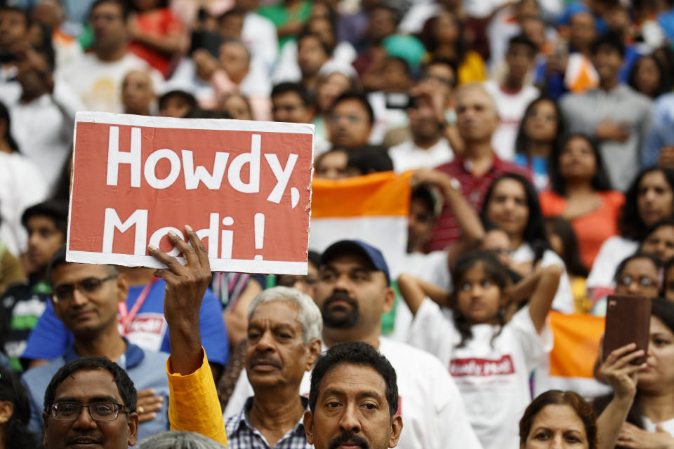 People look on as President Donald Trump arrives to speak at the "Howdy Modi: Shared Dreams, Bright Futures" event with Indian Prime Minister Narendra Modi at NRG Stadium, Sunday, Sept. 22, 2019, in Houston. (AP Photo/Evan Vucci)