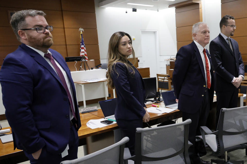 The prosecution team, from left; Assistant State Attorney Christopher Killoran, Assistant State Attorney Kristen Gomes, Assistant State Attorney Steven Klinger and Legal assistant Aaron Savitski stand as prospective jurors enter the courtroom for jury selection in the case of former Marjory Stoneman Douglas High School School Resource Officer Scot Peterson at the Broward County Courthouse in Fort Lauderdale on Wednesday, May 31, 2023. Jury selection began in the trial of the former Florida sheriff's deputy charged with failing to confront the shooter who killed 14 students and three staff members at a Parkland high school five years ago. (Amy Beth Bennett/South Florida Sun-Sentinel via AP, Pool)