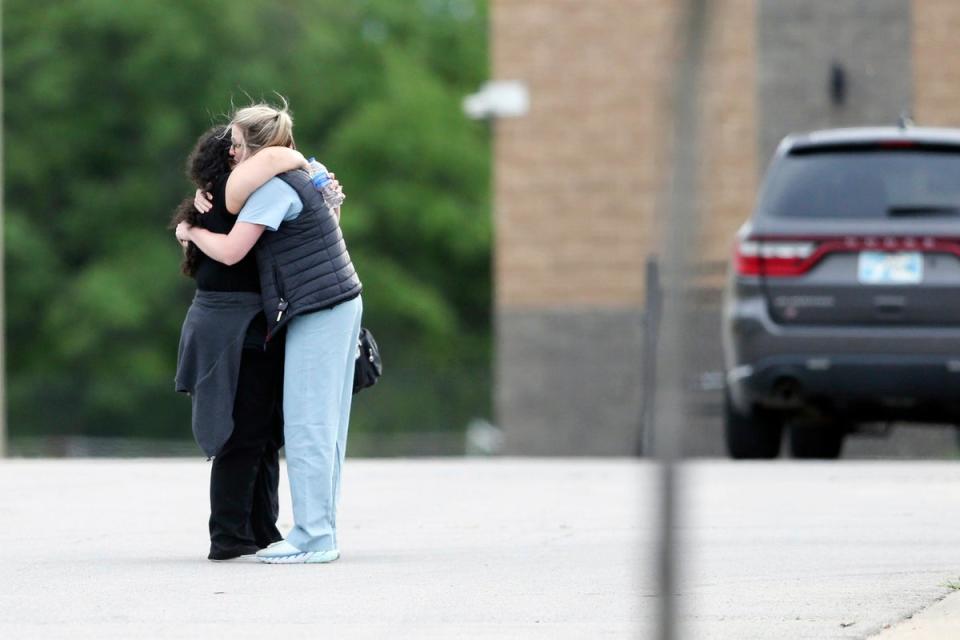 People hug after the gunman stormed the medical building in Tulsa (AP)