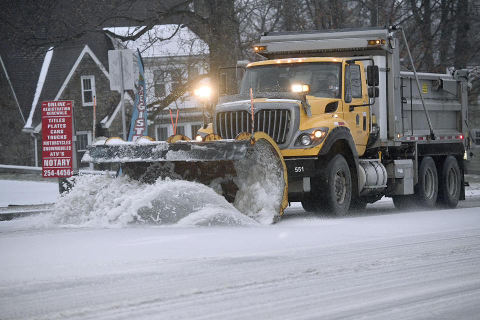 A Pennsylvania Department of Transportation ( Penn Dot) plow truck scraps the ice and sleet away on route 56 in Johnstown, Pa., on Thursday, Dec. 15, 2022. (Todd Berkey/The Tribune-Democrat via AP)
