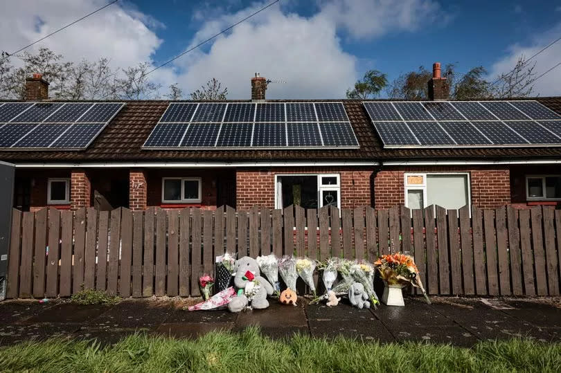 Flowers and toys left at the scene on Marsh Green, Wigan.