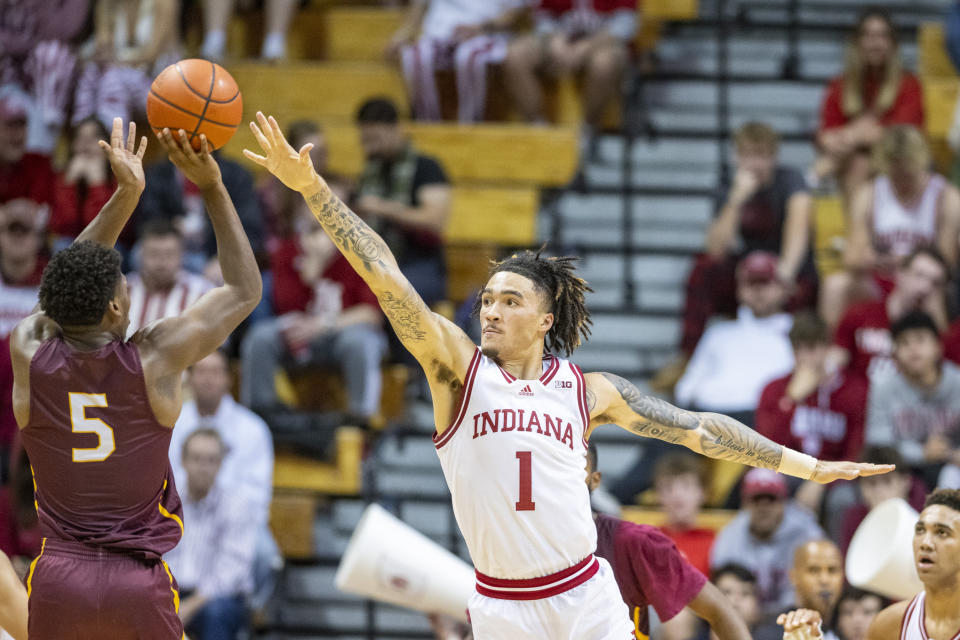 Indiana guard Jalen Hood-Schifino (1) attempts to block a shot by Bethune-Cookman guard Damani McEntire (5) during the second half of an NCAA college basketball game, Thursday, Nov. 10, 2022, in Bloomington, Ind. (AP Photo/Doug McSchooler)