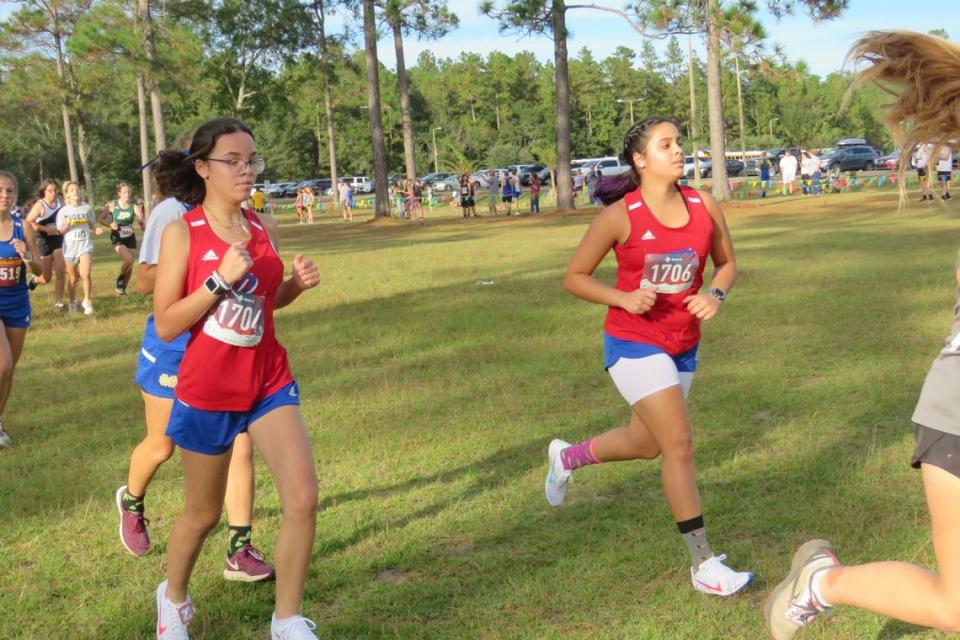 Sisters Naomi and Alanys Rodriguez run in the regional cross country meet on Oct. 26, 2021.