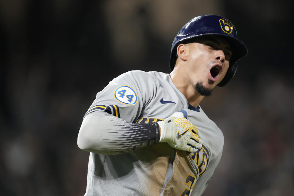 Milwaukee Brewers' Willy Adames reacts after hitting a two-run home run off Colorado Rockies relief pitcher Tyler Kinley during the ninth inning of a baseball game Saturday, June 19, 2021, in Denver. (AP Photo/David Zalubowski)