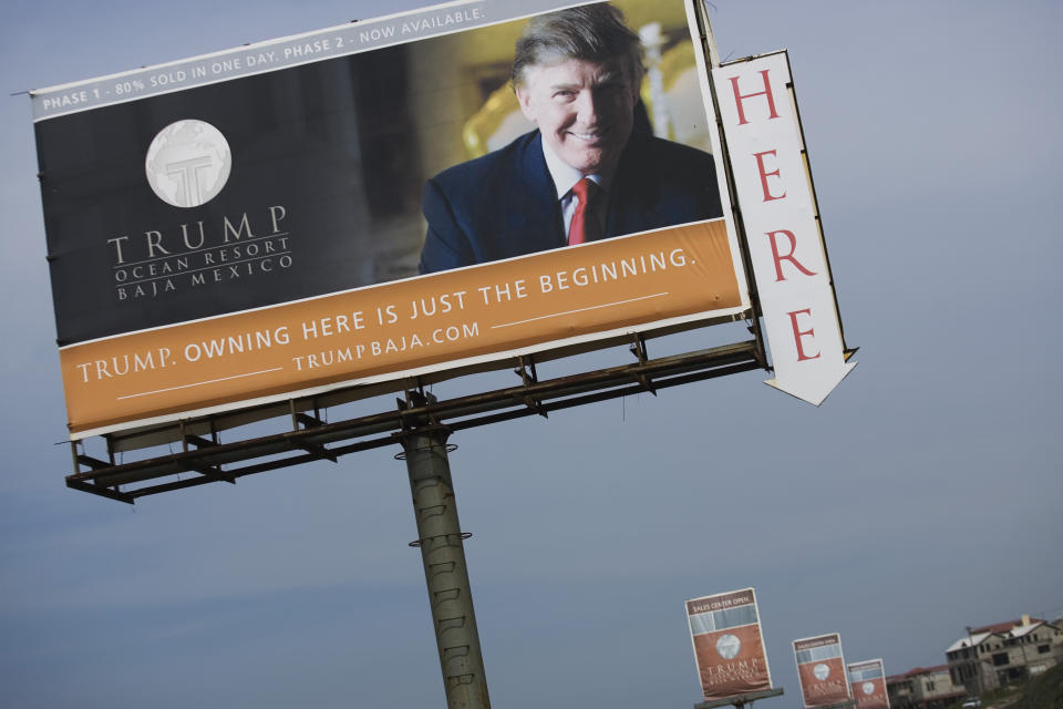 FILE - This Feb. 27, 2009 file photo shows a Trump Ocean Resort Baja highway billboard with a photo of Donald Trump that advertises condos for sale on the outskirts of Tijuana, Mexico. Last decade Trump and his children promoted a luxury hotel and condo development with the Trump name on it that was planned for the northern Baja California coast. But the Trump Ocean Resort Baja Mexico project collapsed, and dozens of buyers who had lost their 30 percent deposits sued in March 2009. (AP Photo/Guillermo Arias, File)