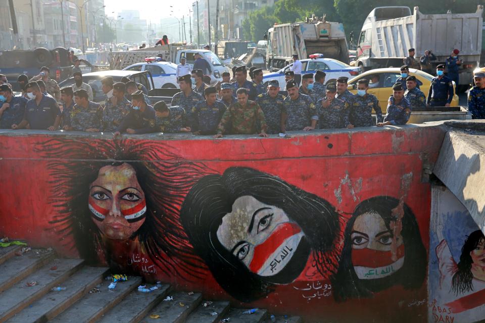 Security forces are deployed at anti-government protesters' site to remove protesters' tents in Tahrir Square, Baghdad, Iraq, Saturday, Oct. 31, 2020. (AP Photo/Khalid Mohammed)