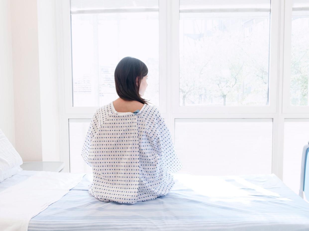 Woman in a hospital gown.