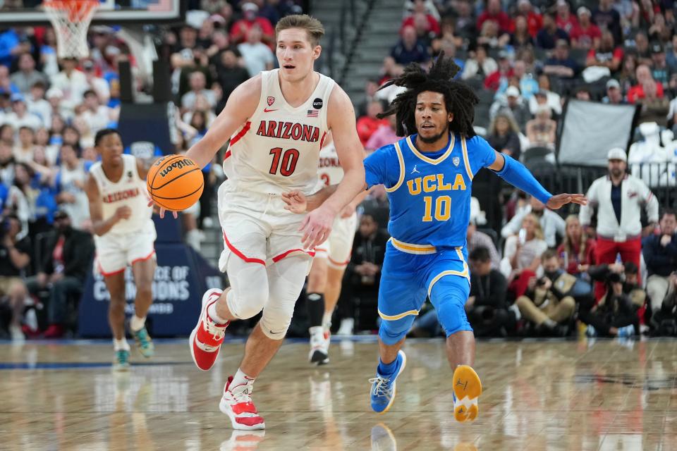 Arizona forward Azuolas Tubelis (10) dribbles while chased by UCLA guard Tyger Campbell (10) during the second half of the 20222 Pac-12 tournament at T-Mobile Arena.
