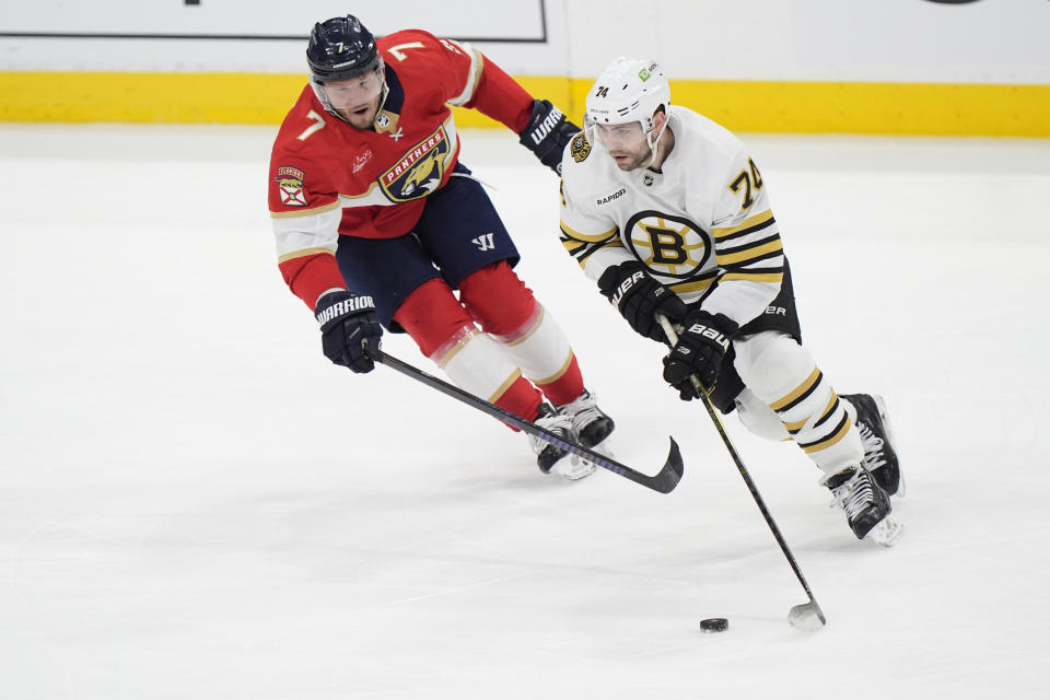 Boston Bruins left wing Jake DeBrusk (74) takes the puck down the ice against Florida Panthers defenseman Dmitry Kulikov (7) during the second period of Game 1 of the second-round series of the Stanley Cup Playoffs, Monday, May 6, 2024, in Sunrise, Fla. (AP Photo/Wilfredo Lee)