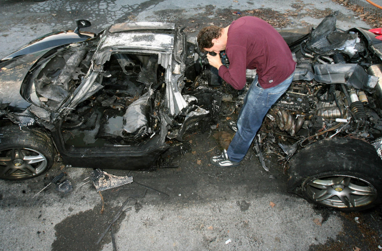 A journalist films the wreck of a black (Valery Hache / AFP via Getty Images file)