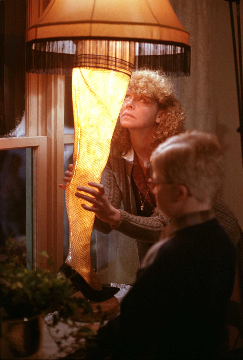 Melinda Dillon and Peter Billingsley appear with the famed leg lamp in a scene from the 1983 movie "A Christmas Story." To mark its 40th anniversary, the film is returning to theaters nationwide Dec. 10 and 13 via Fathom Events.