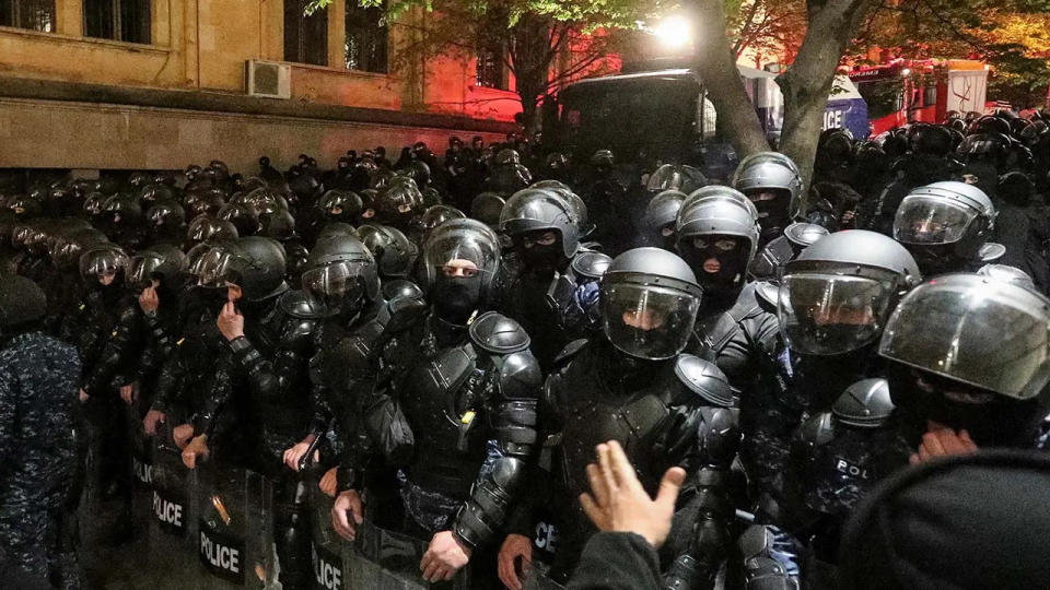 Law enforcement officers block a street during a protest against a draft bill on "foreign agents" in Tbilisi, Georgia, on April 15.