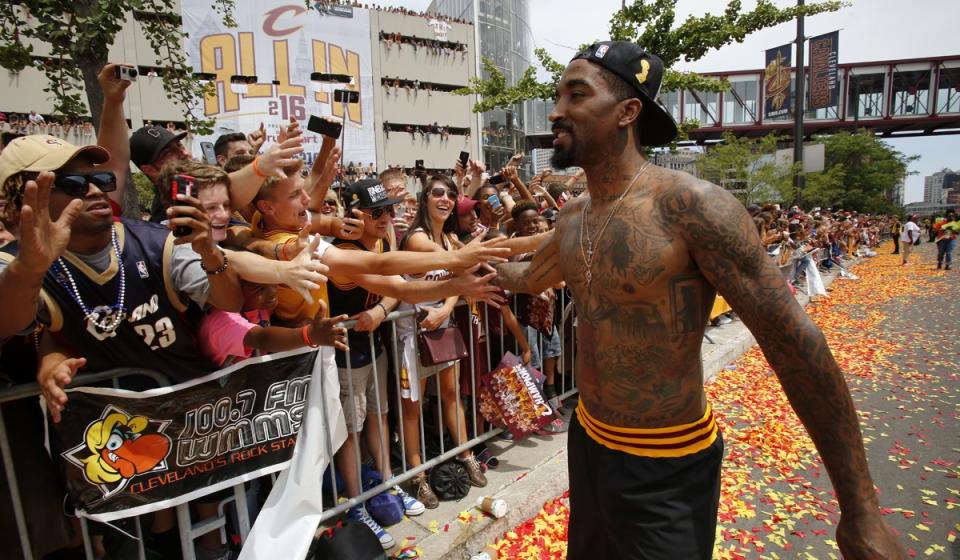 Cleveland Cavaliers' J.R. Smith greets fans before the start of a parade celebrating the team's 2016 NBA championship.